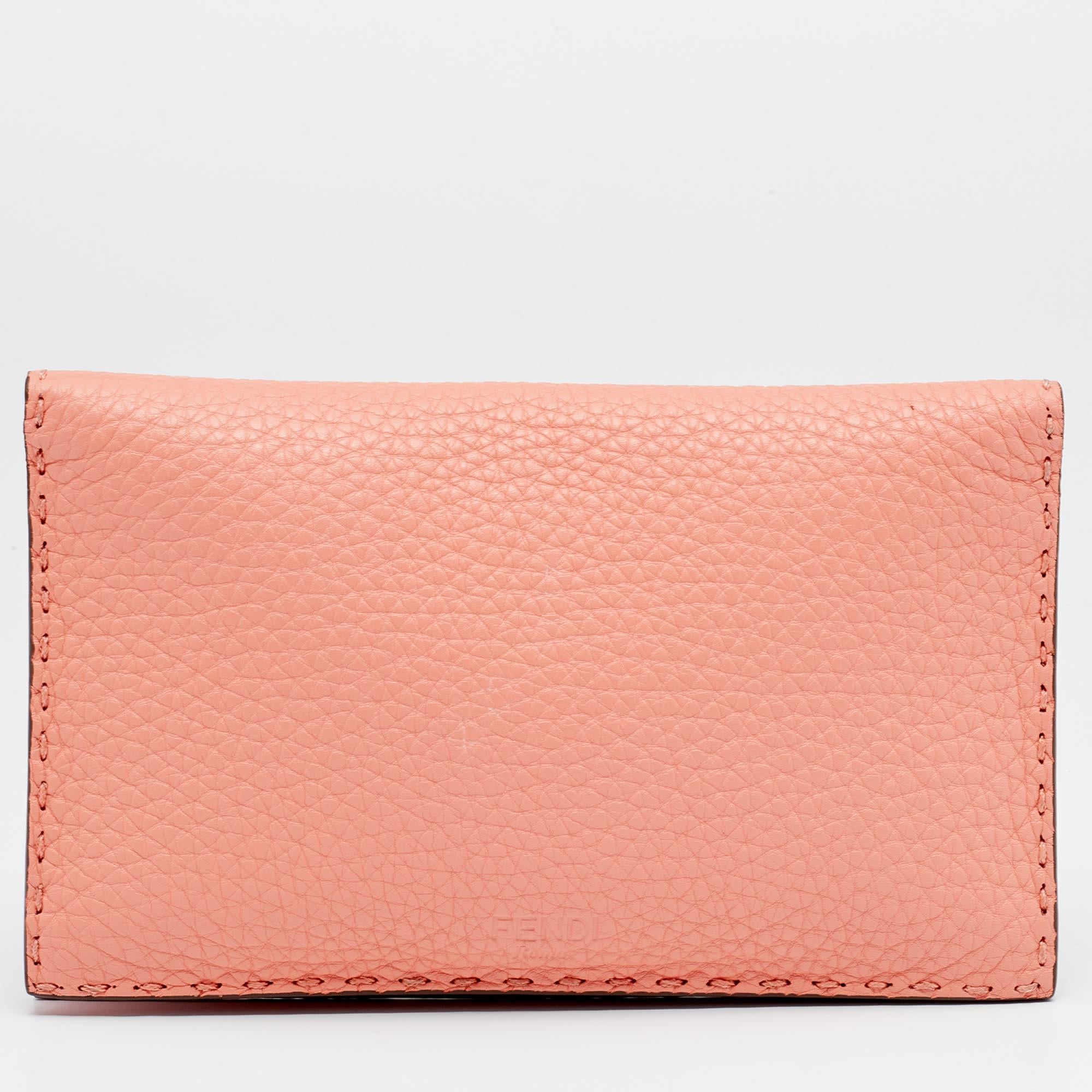 Made using peach leather, this Peekaboo wallet from Fendi has a simple look and functional quality. The exterior has a twist lock and the Selleria motif and the interior has enough space for cards, cash, and receipts.

Includes: Original Dustbag