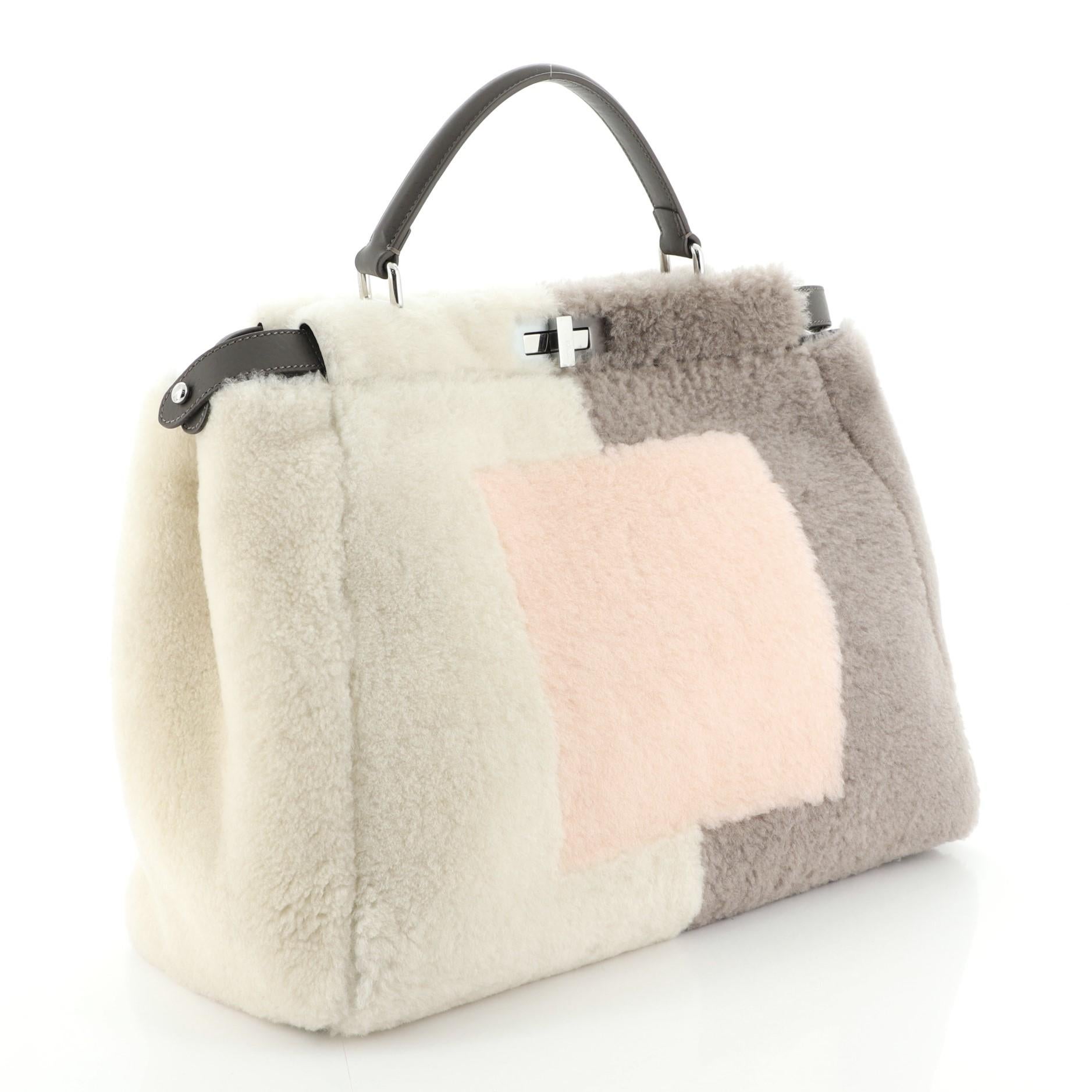 Estimated Retail Price: $3,250
Condition: Very good. Loss of shape on exterior, minor wear on handle, scratches on hardware. 
Accessories: With Strap 
Measurements: 
Designer: Fendi
Model: Peekaboo Bag Shearling Large
Exterior Material: Shearling