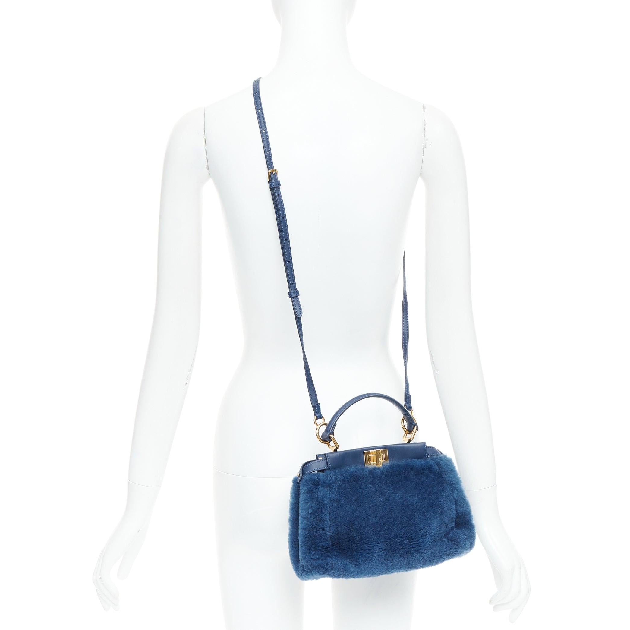 FENDI Peekaboo blue shearling fur gold hardware turnlock crossbody satchel
Reference: NILI/A00100
Brand: Fendi
Model: Peekaboo
Material: Shearling
Color: Blue, Gold
Pattern: Solid
Closure: Turnlock
Lining: Blue Leather
Extra Details: FENDI Shearling