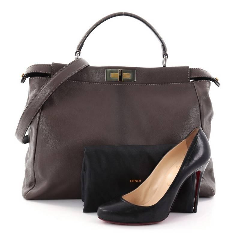 This authentic Fendi Peekaboo Handbag Leather Large is one of Fendi's best known designs exuding a luxurious yet minimalist appearance. Crafted in brown leather, this versatile and stylish satchel features a flat leather top handle, protective base