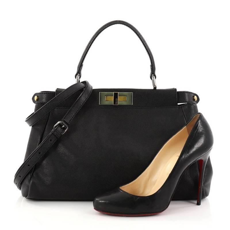 This authentic Fendi Peekaboo Handbag Leather Regular is one of Fendi's best-known designs, exuding a luxurious yet minimalist appearance. Crafted in black leather, this versatile and stylish satchel features flat leather top handle, protective base