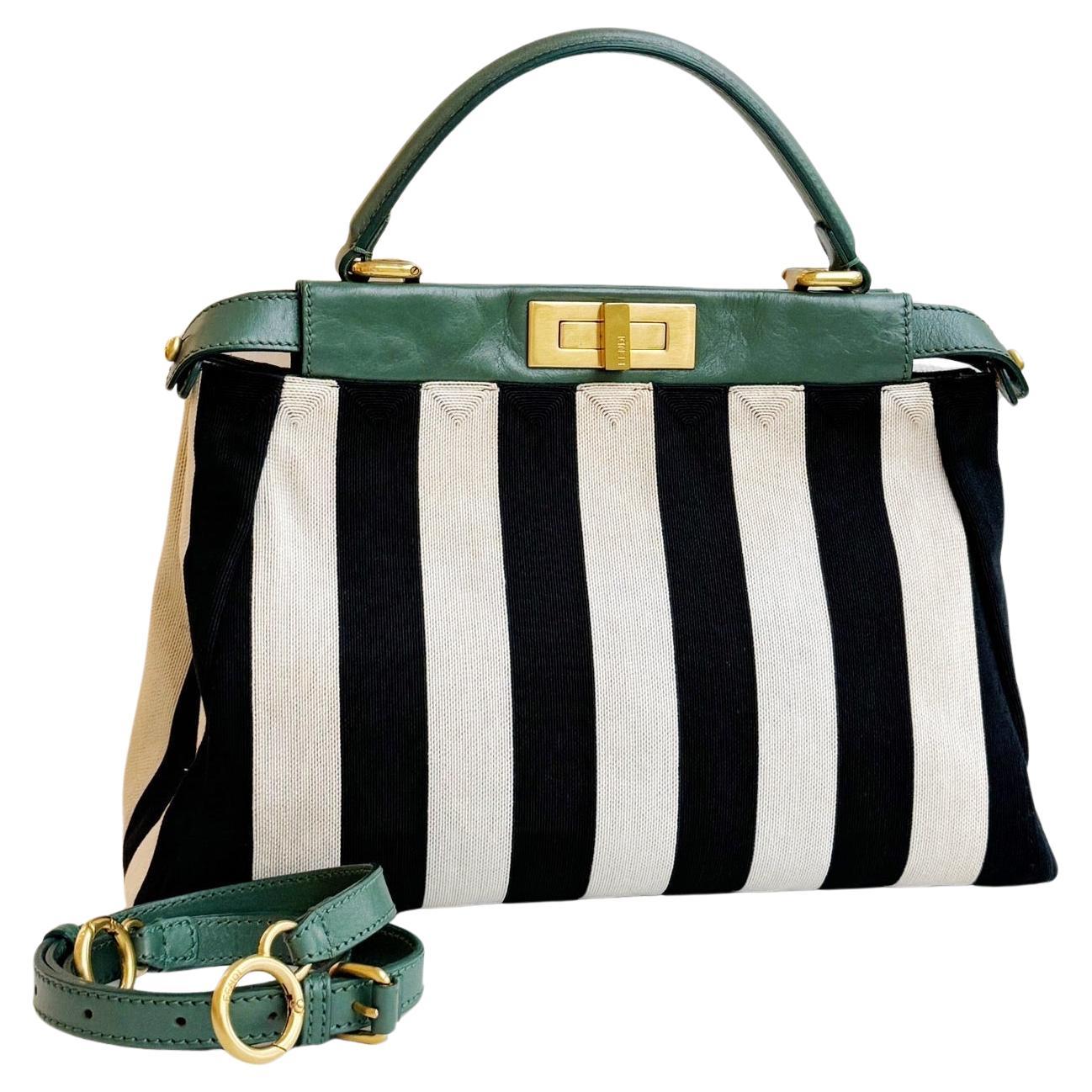This Fendi Peekaboo is part of the 2012 Spring/Summer collection by Fendi. It is made of black and white striped canvas and green leather, giving a peek into the multicolor beaded interior on one side and opening to show green suede on the other.
