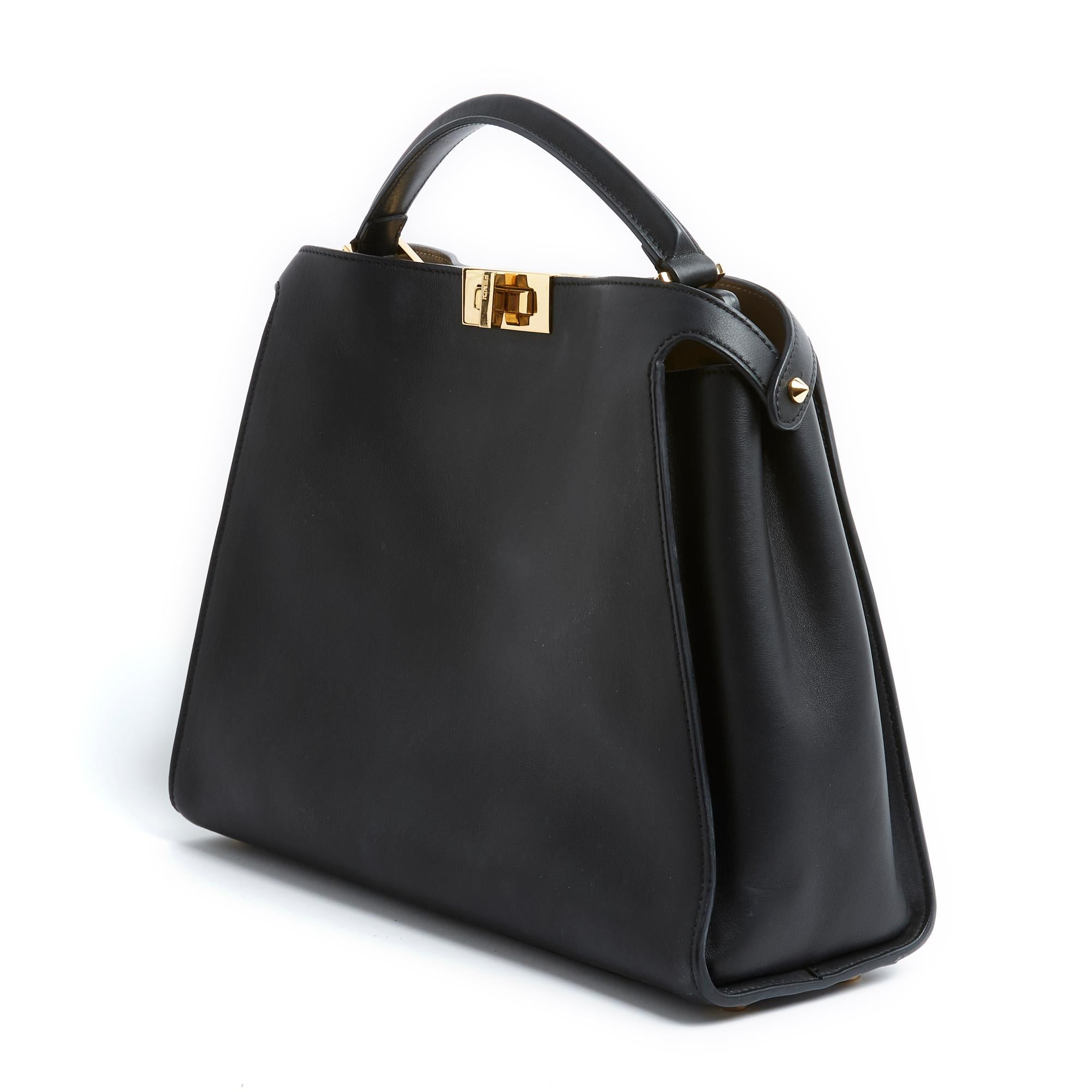 Fendi Large Peekaboo model bag in soft black leather, interior in taupe beige leather, one side of which has a large pocket closed with a zip, gold metal swivel clasps, handle for carrying in the hand and wide removable shoulder strap in matching