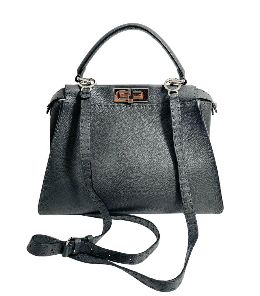 Fendi Peekaboo Medium Model Leather Bag

Grey in pebbled selleria leather with silver hardware.

Top carry handle and removable shoulder strap. Rrp £3,900

Size - Height 26cm, Width 32cm, Depth 11cm - Medium Model

Condition - Very Good (Some light