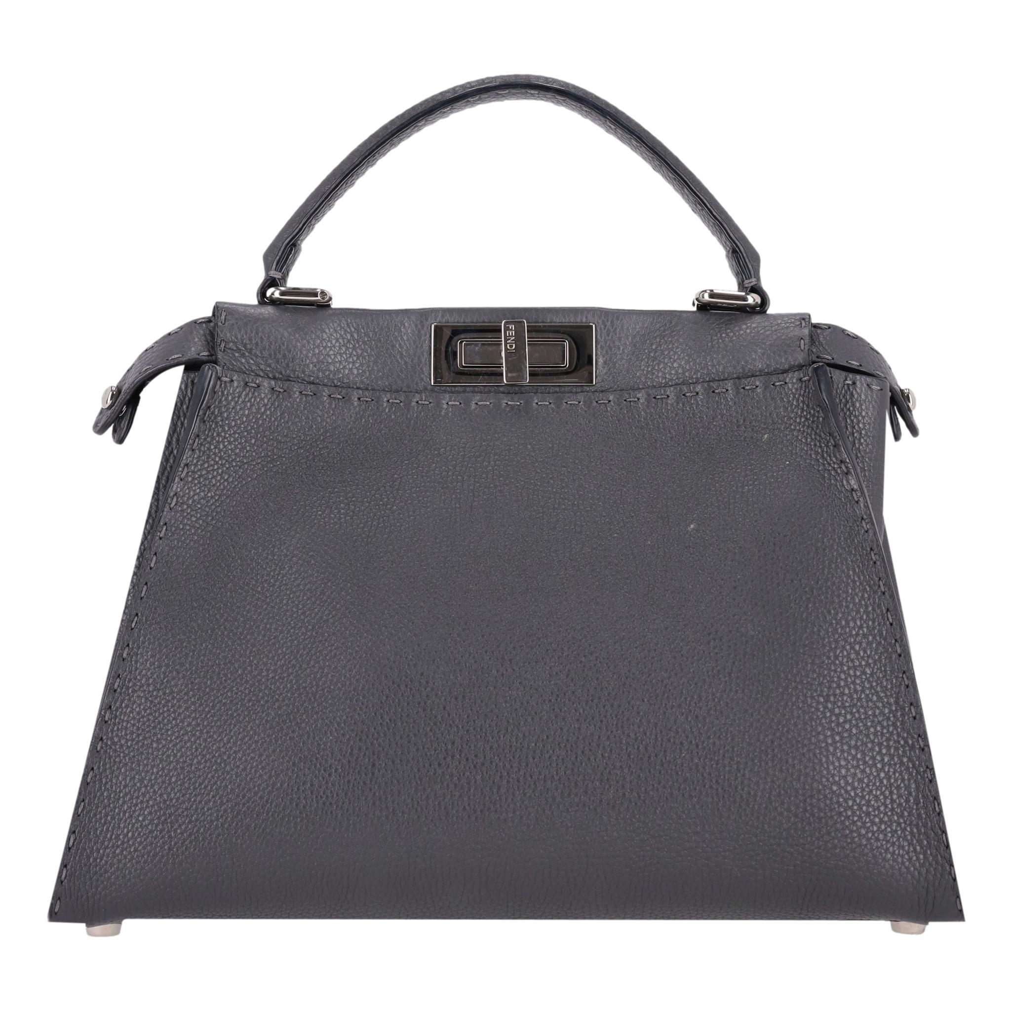 Fendi Peekaboo Medium Model Leather Tote Bag

Grey tote bag in pebbled Selleria leather and branded, silver hardware.

Featuring 'Fendi' engraved twist-lock closure, leather top carry handle and removable, adjustable shoulder strap.

Spacious