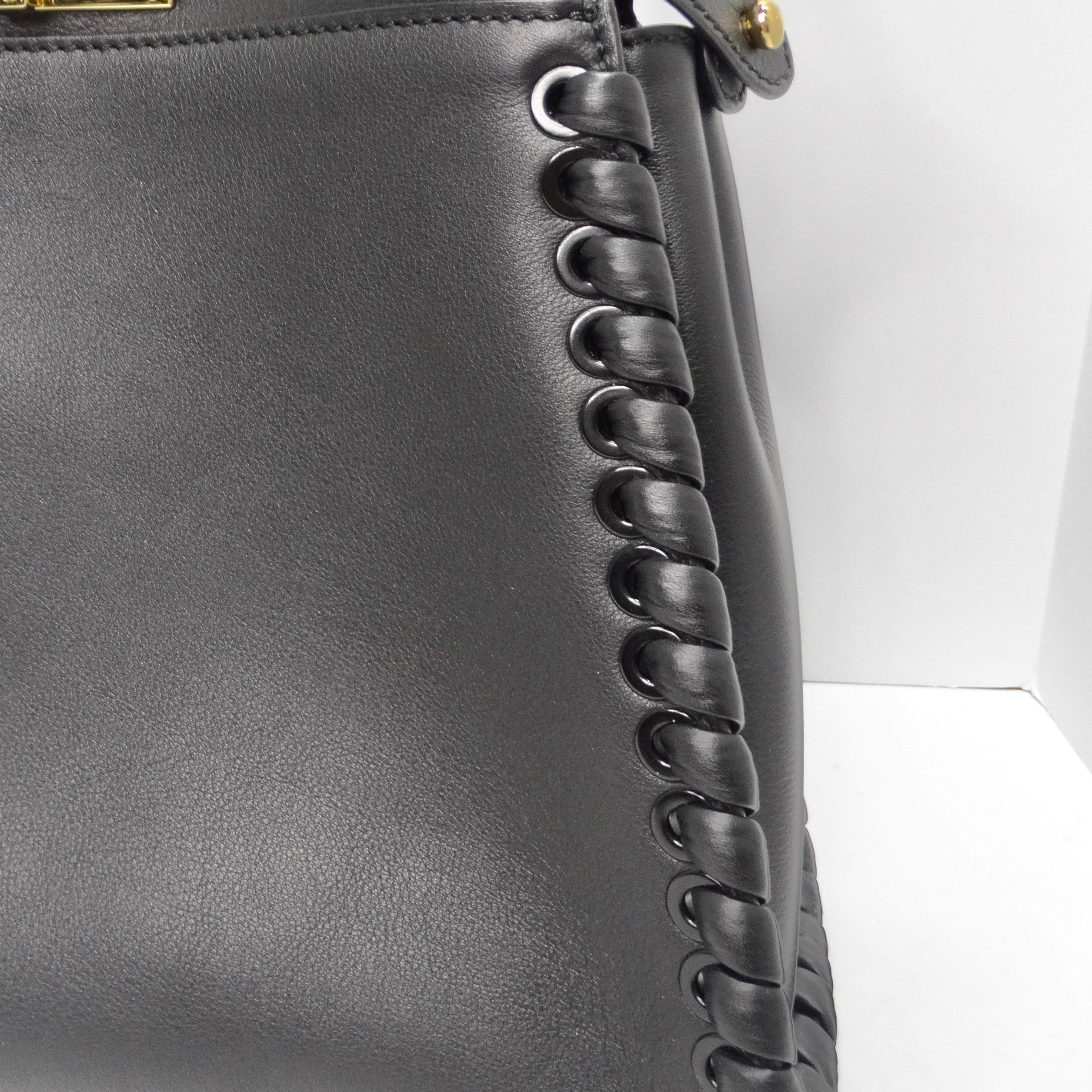 Indulge in the epitome of luxury and craftsmanship with the Fendi Peekaboo Medium Whipstitch Shoulder Bag. Meticulously crafted from sumptuous leather, this exquisite bag showcases the art of whipstitched details and boasts a convenient top handle