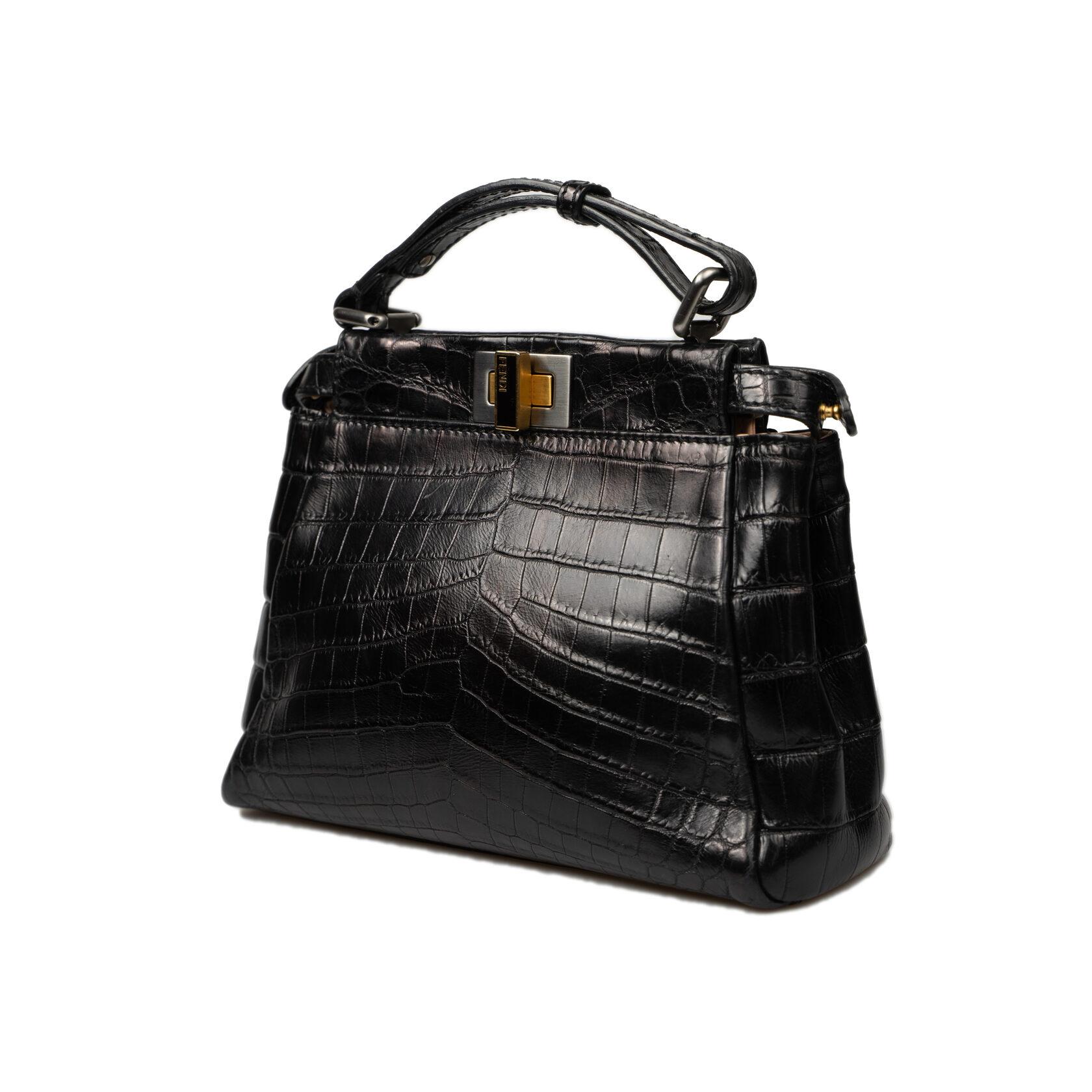 CONDITION: A: Excellent condition; carefully kept
PACKAGE: Adjustable shoulder strap
SIZE: 22/18/7 cm Adjustable shoulder strap min 101 cm - max 133 cm.
BRAND: FENDI
MODEL: Peekaboo Mini
Black color
MATERIAL: Crocodile Skin
COLOR OF INNER CONE: