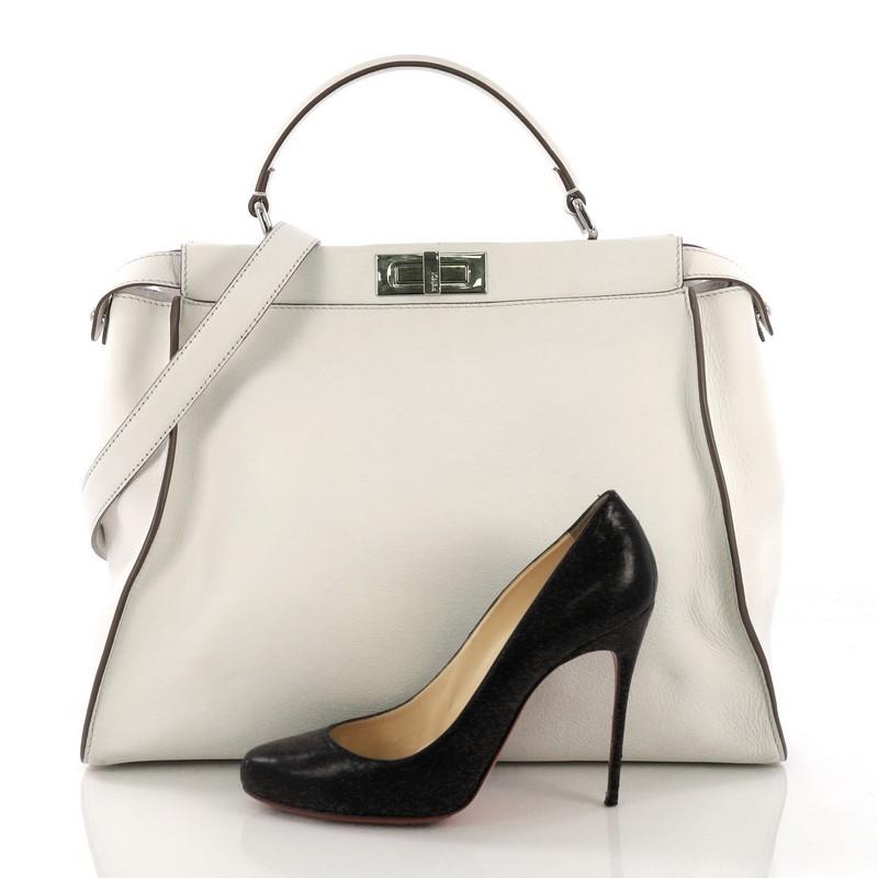 This Fendi Peekaboo Monster Handbag Leather with Fur Interior Large, crafted from white leather, features a short leather top handle and silver-tone hardware. Its two compartments with press-lock and zip closures open to a white leather and fur