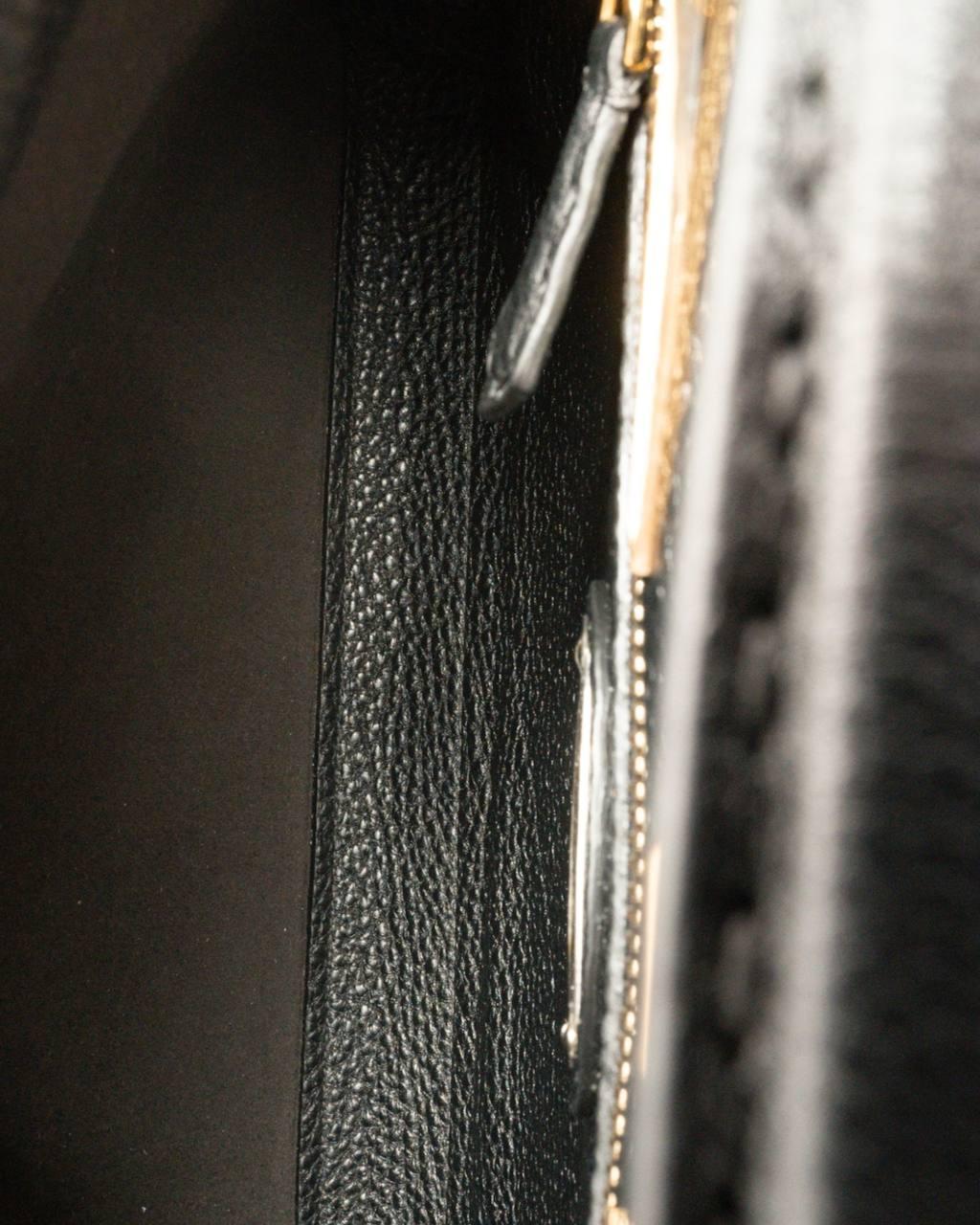 Fendi signature bag, Peekaboo Monster model, made of black grained leather with gold hardware. Featuring a double top zipper and interlocking closure, internally lined in tone-on-tone suede fabric with multiple pockets, very roomy. Equipped with a