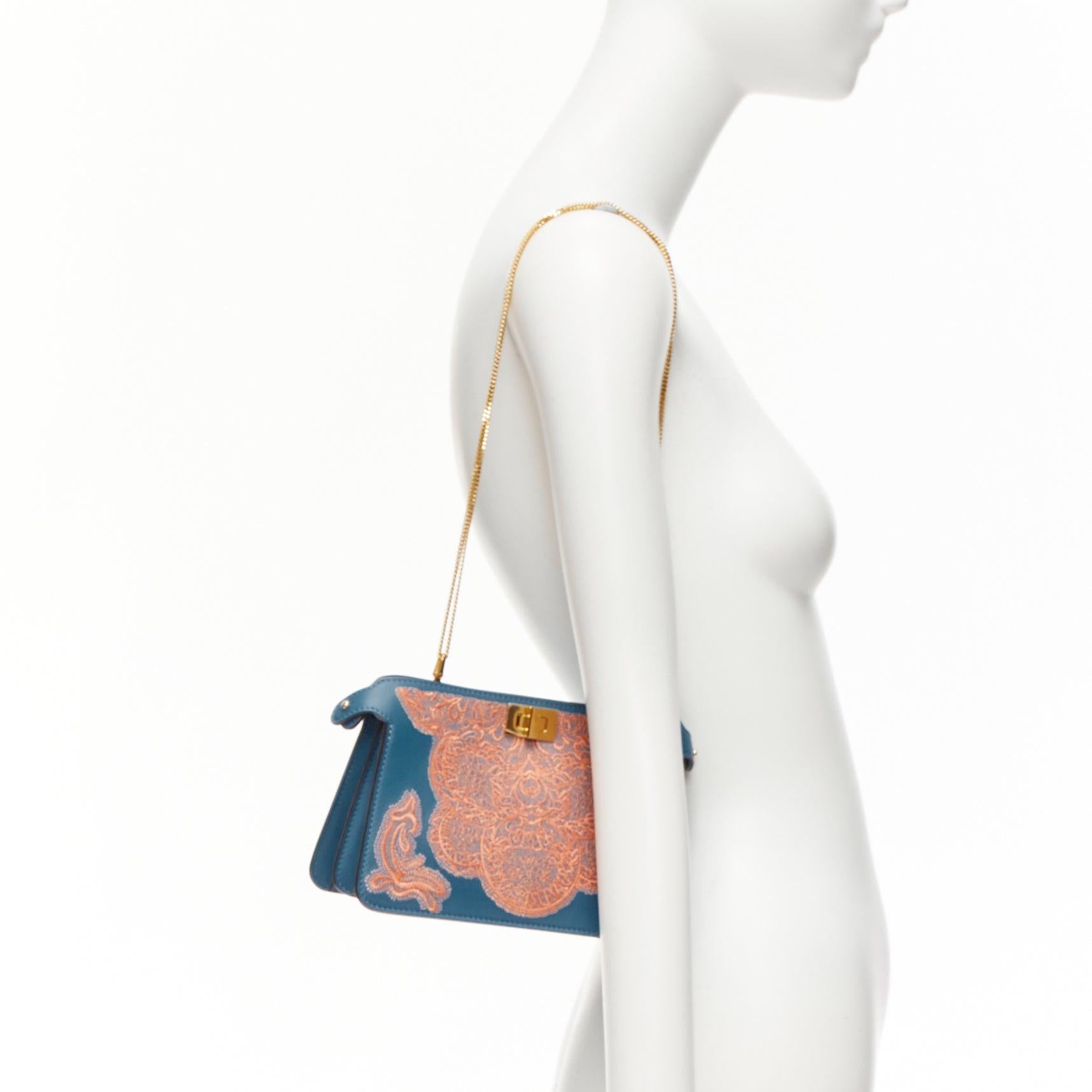 FENDI Peekaboo pink lace applique blue leather gold buckle crossbody bag
Reference: AAWC/A00942
Brand: Fendi
Model: Peekaboo
Material: Leather
Color: Blue, Pink
Pattern: Lace
Closure: Turnlock
Lining: Blue Leather

CONDITION:
Condition: Unworn in