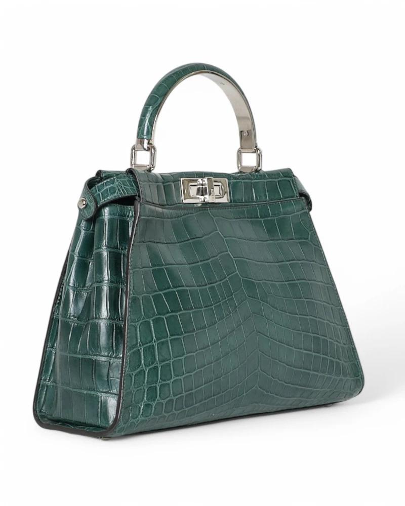 Fendi signature bag, Peekaboo model in medium size, made of leather in green color with silver hardware. Featuring a double front-back swivel closure, internally lined in smooth tone-on-tone leather with convenient pocket, the bag is quite roomy.