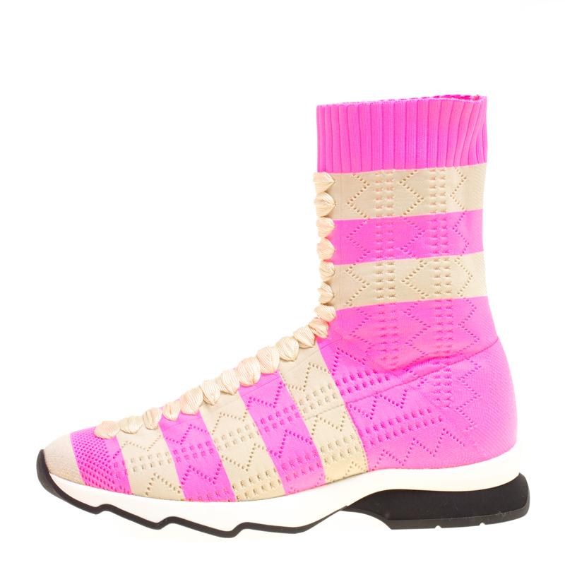 Made from a cotton blend knit fabric in a pretty pink hue, these boots styled like sneakers from Fendi are a must-have for the modern women. They feature a perforated striped pattern all over with a feminine design at the centre. They have