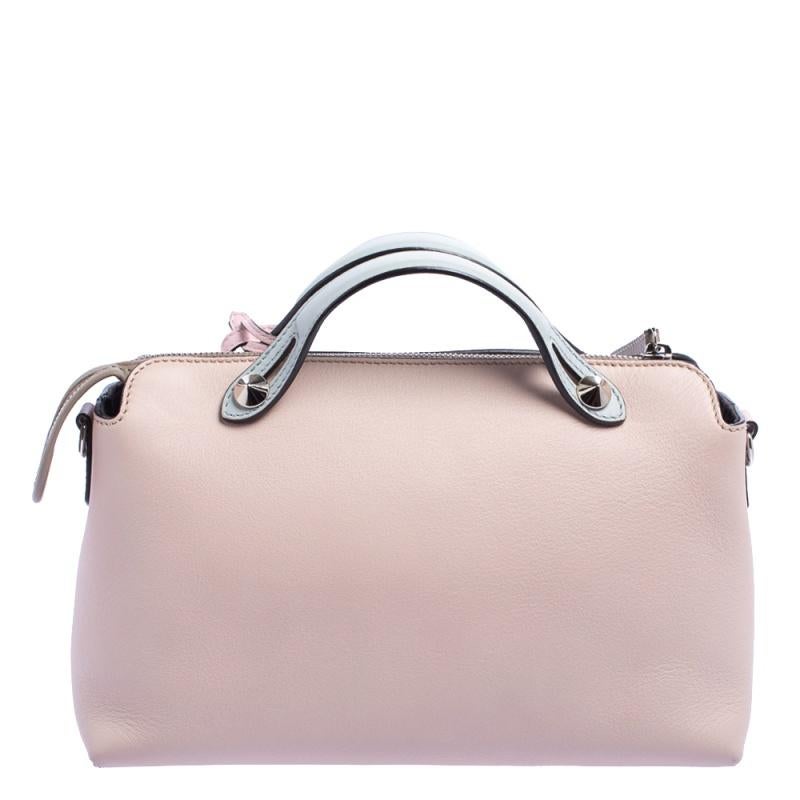 This By The Way Boston bag by Fendi sweetly embodies ladylike elegance! Crafted from leather in a mix of blue and pink, this pretty bag features a top zip closure that opens to a canvas interior housing the brand label and a zippered pocket. It is