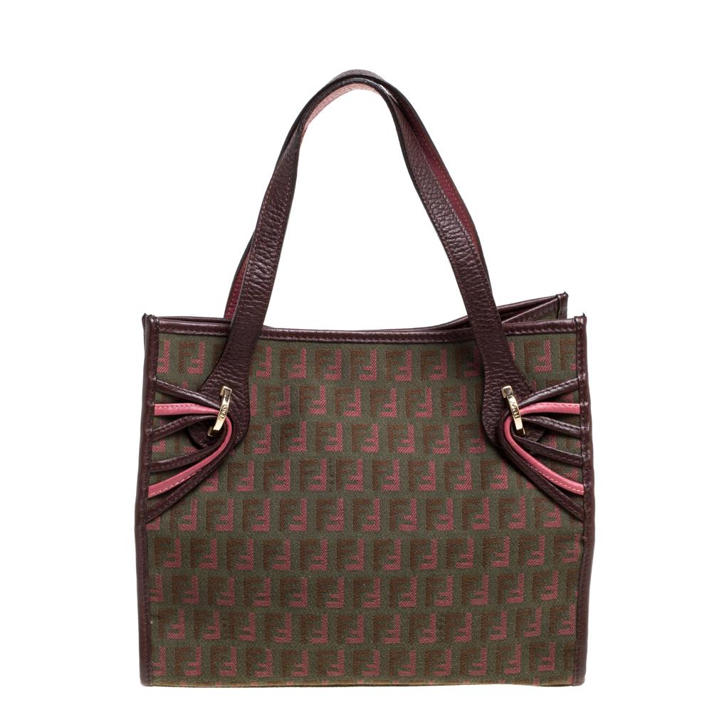 This striking tote by Fendi is a fine handbag to own. The exterior is made from Zucchino canvas, leather, and gold-tone hardware. It is finished with two handles and a spacious interior for your essentials.

