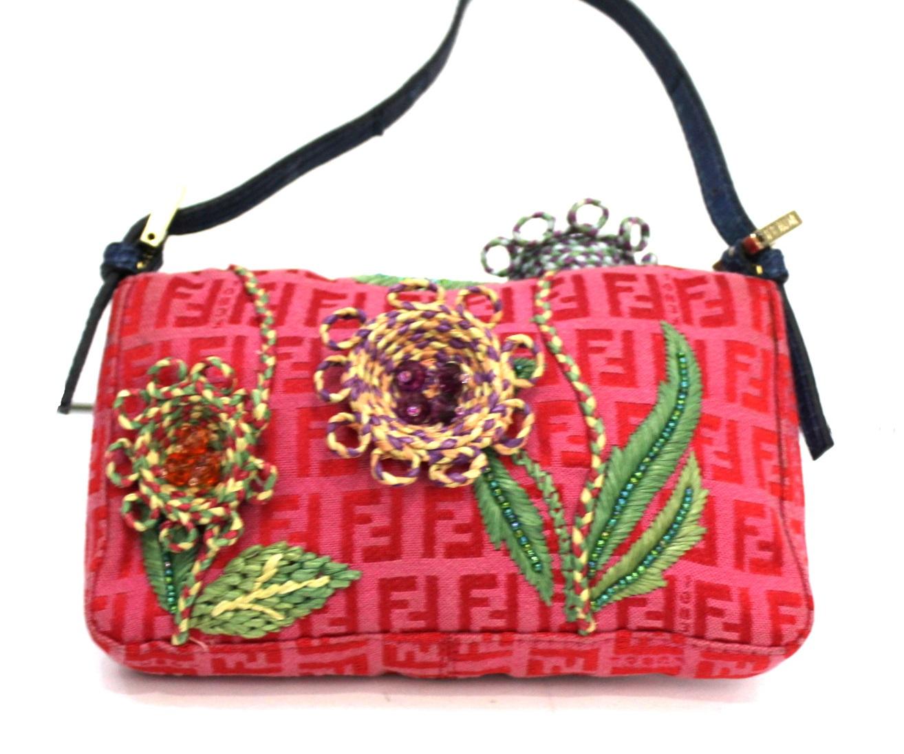 Fantastic Fendi Baguette made of pink logo fabric with blue leather details. The bag is certainly special, covered with flowers.
It is in good condition