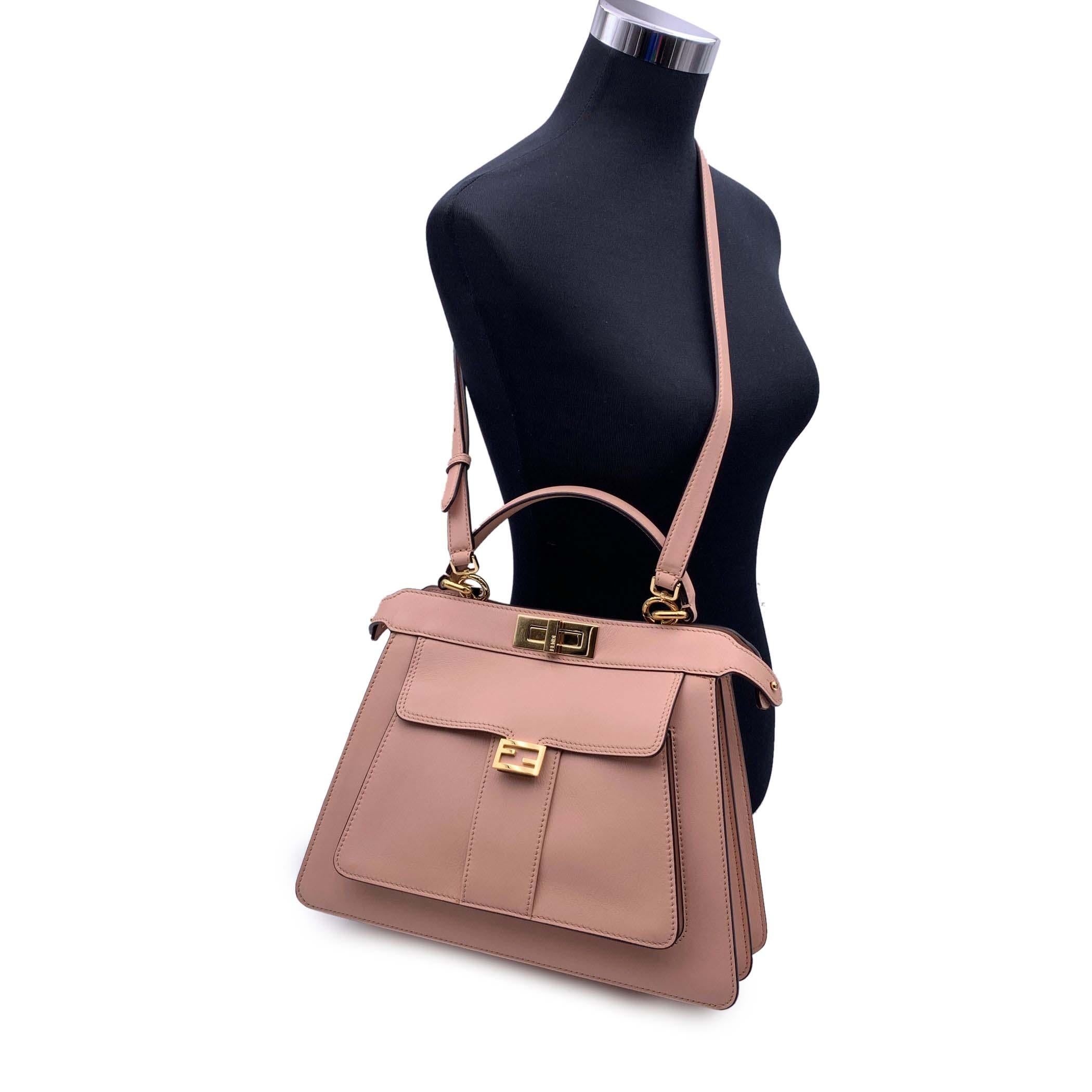 This beautiful Bag will come with a Certificate of Authenticity provided by Entrupy. The certificate will be provided at no further cost. Beautiful Fendi Selleria 'Peekaboo ISeeU' Bag in baby pink leather. The bag features 2 compartments divided by