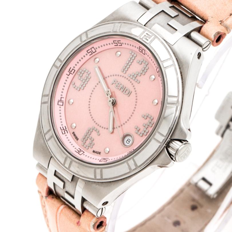 This Fendi Swiss-made High Speed watch is crafted from stainless steel and it carries the brand's signature logo on the case. The watch has a pink mother of pearl dial with three hands and Arabic numeral hour markers. It is also equipped with a date