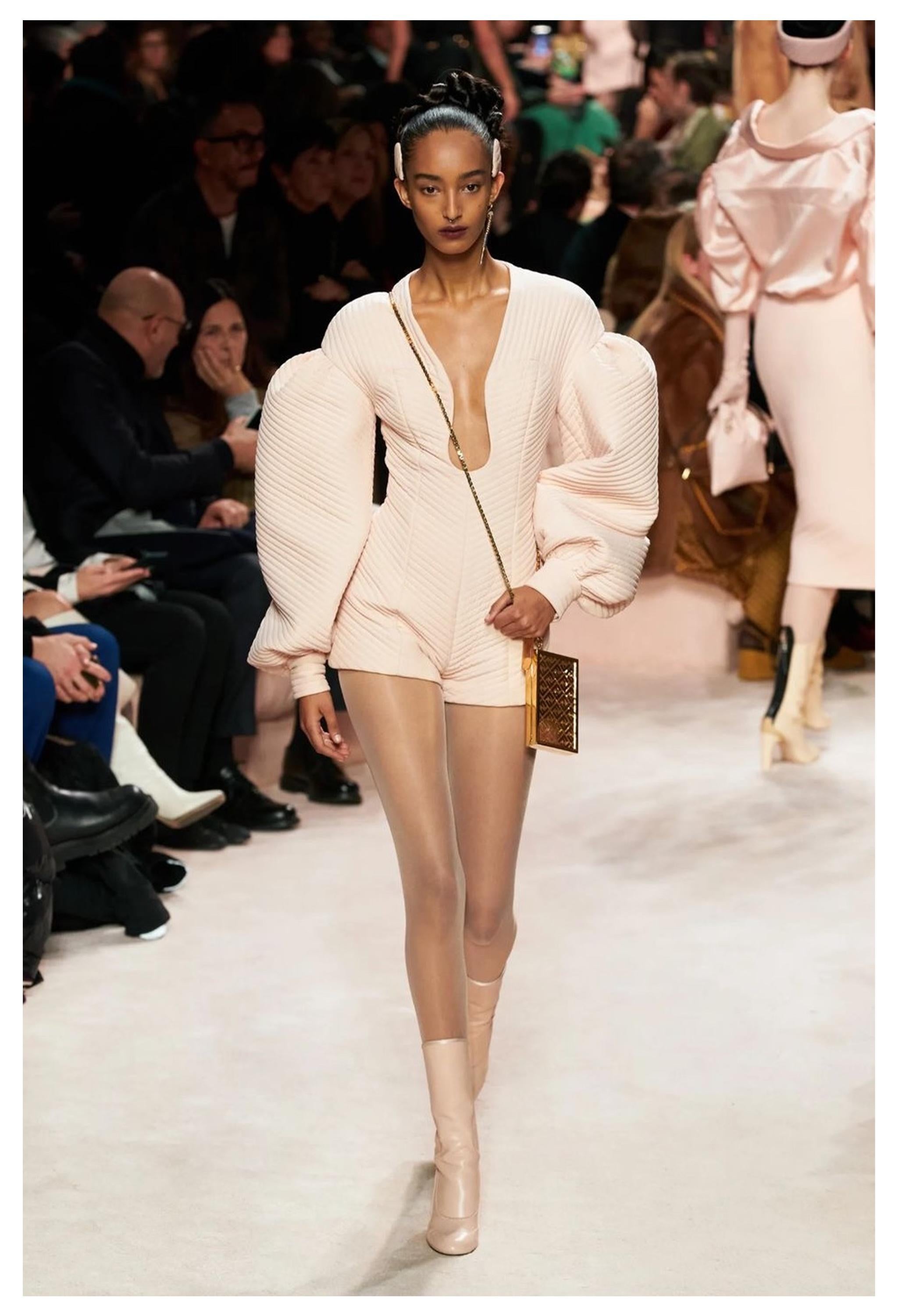 Resurrection Vintage is excited to offer a stunning Fendi soft pink padded romper jumpsuit featuring deep cutout at the neckline, sculptural sleeves, button cuffs, and romper shorts.  

Fendi

Size: 38
Fabric: 100% Silk 
Excellent Vintage