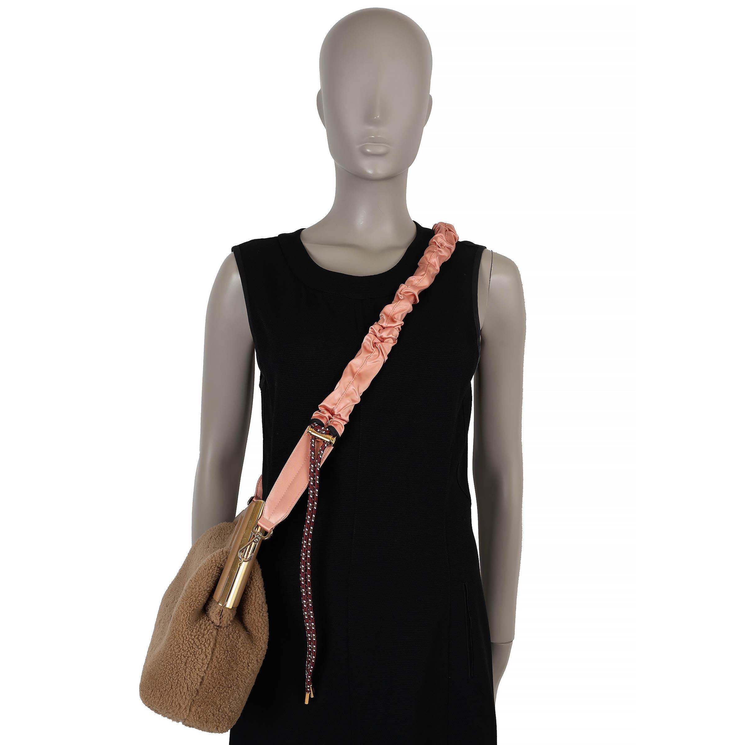 This 100% authentic Fendi Strap You bag strap is crafted in baby pink silk satin paired with burgundy climbing rope for a modern, sporty-luxe aesthetic. Featuring gold-tone hardware, it is designed with adjustable toggles on each side, allowing you
