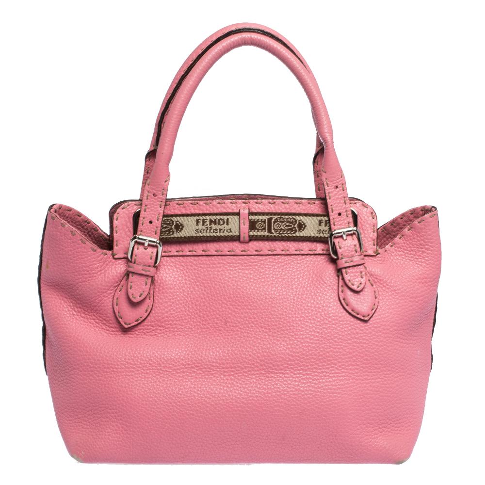 This beautiful pink Fendi Borghese tote has been skilfully crafted in leather. The exterior features embossed horse crest at the front, a brand name tag and rolled top leather handles. The belt and buckle details accented with signature Selleria