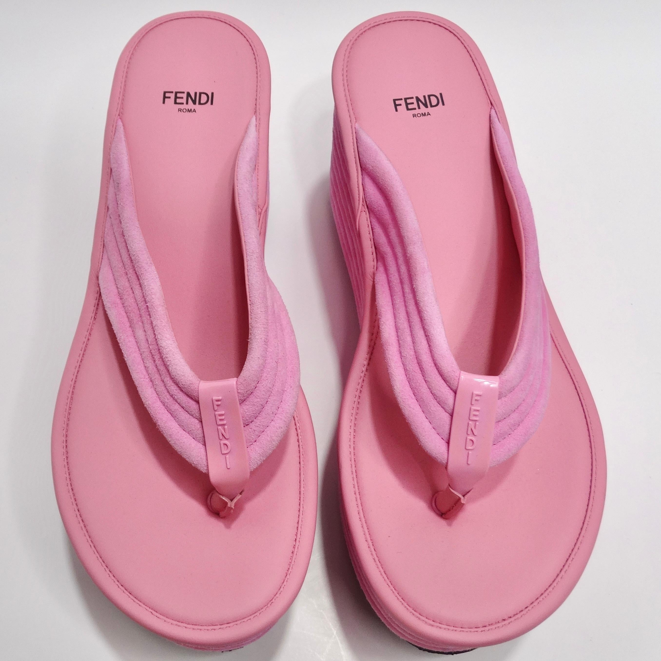 Elevate your summer style with the Fendi Pink Suede Platform Flip Flops. These jumbo platform flip flops are designed to make a statement, combining bold design elements with luxurious materials.

Crafted from vibrant pink suede, these flip flops