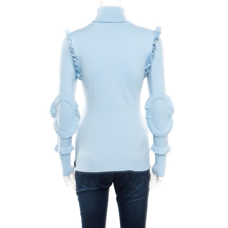 We feel this Fendi creation hits the note on high-fashion effortlessly. It is made from cashmere and designed with ruffled elbow patches, ruffle trims along the arm holes and a turtle neck. You may pair this powder blue delight with high-waist