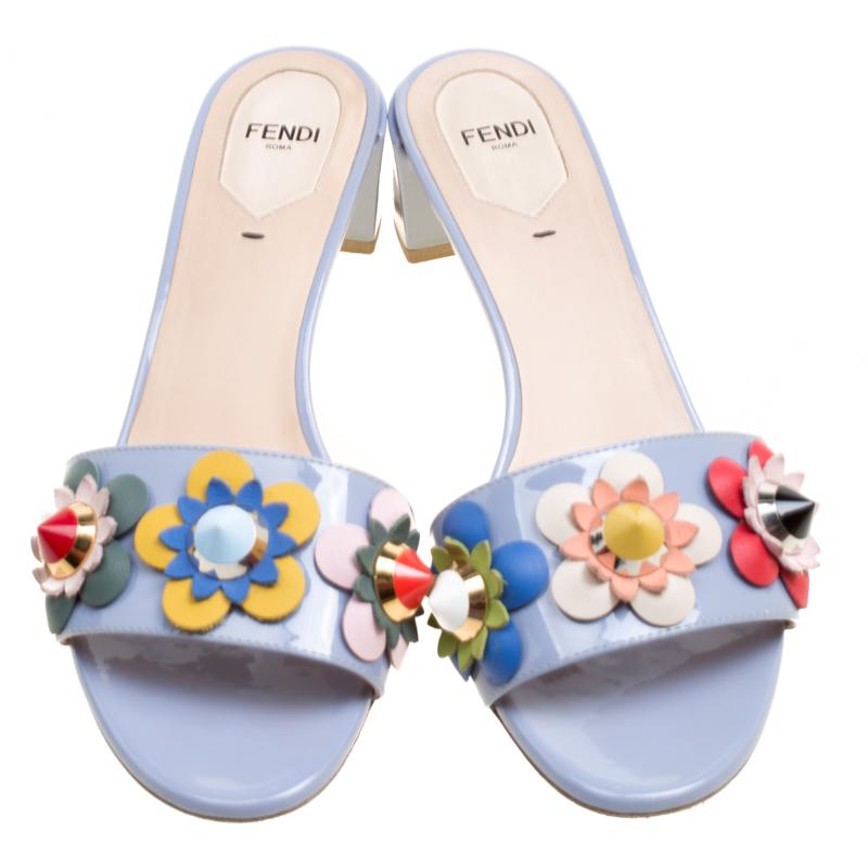 Exquisite and enchanting, these Flowerland slides from Fendi are worth every penny you spend! The powder blue slides are crafted from patent leather and feature an open toe silhouette. They've been embellished with colourful flower motifs on the