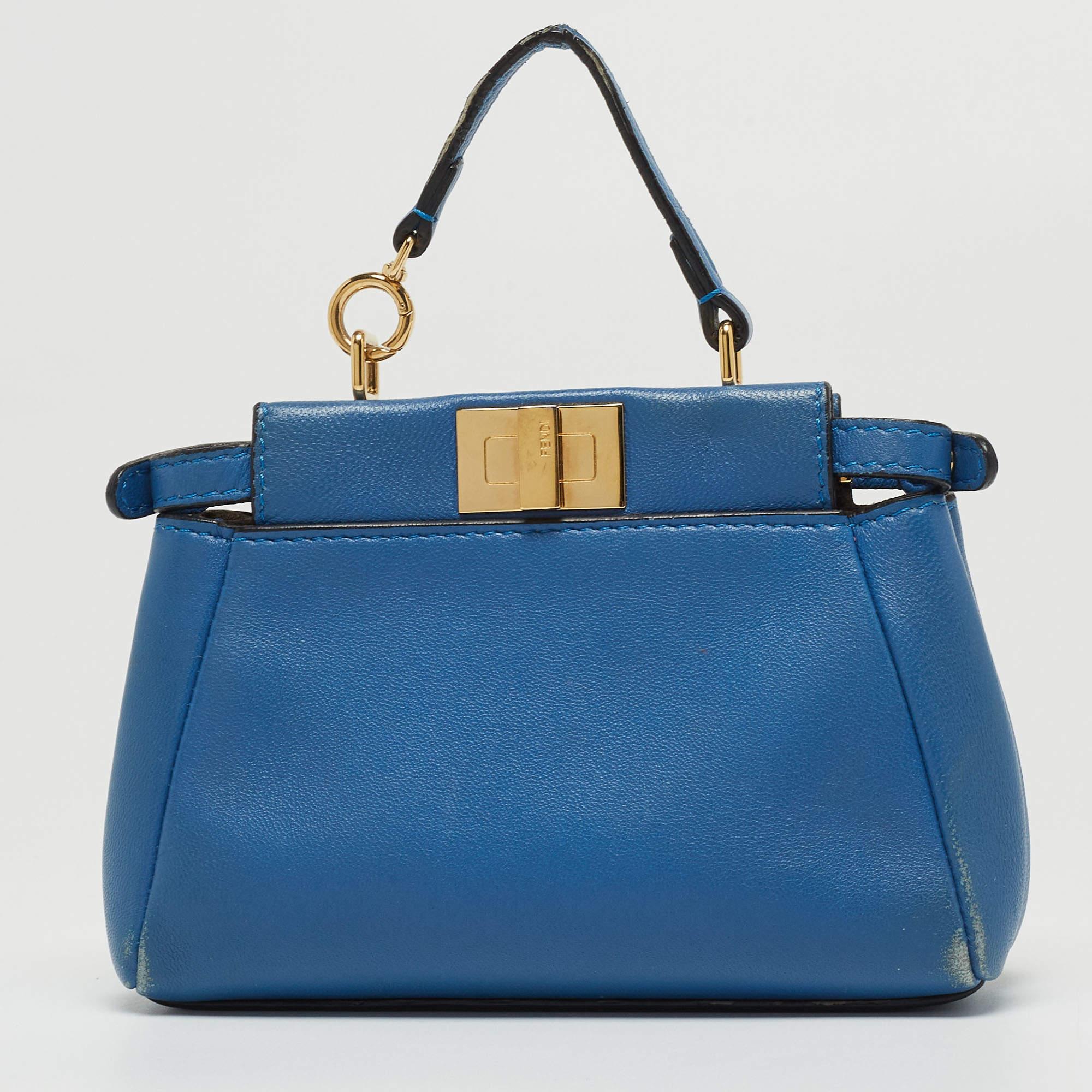 The iconic 'Peekaboo' collection from the house of Fendi is reinvented in a micro-silhouette for the spring. Designed in a luxe blue hue, this refined bag comes with a top handle and a shoulder strap. It features polished silver hardware and secured