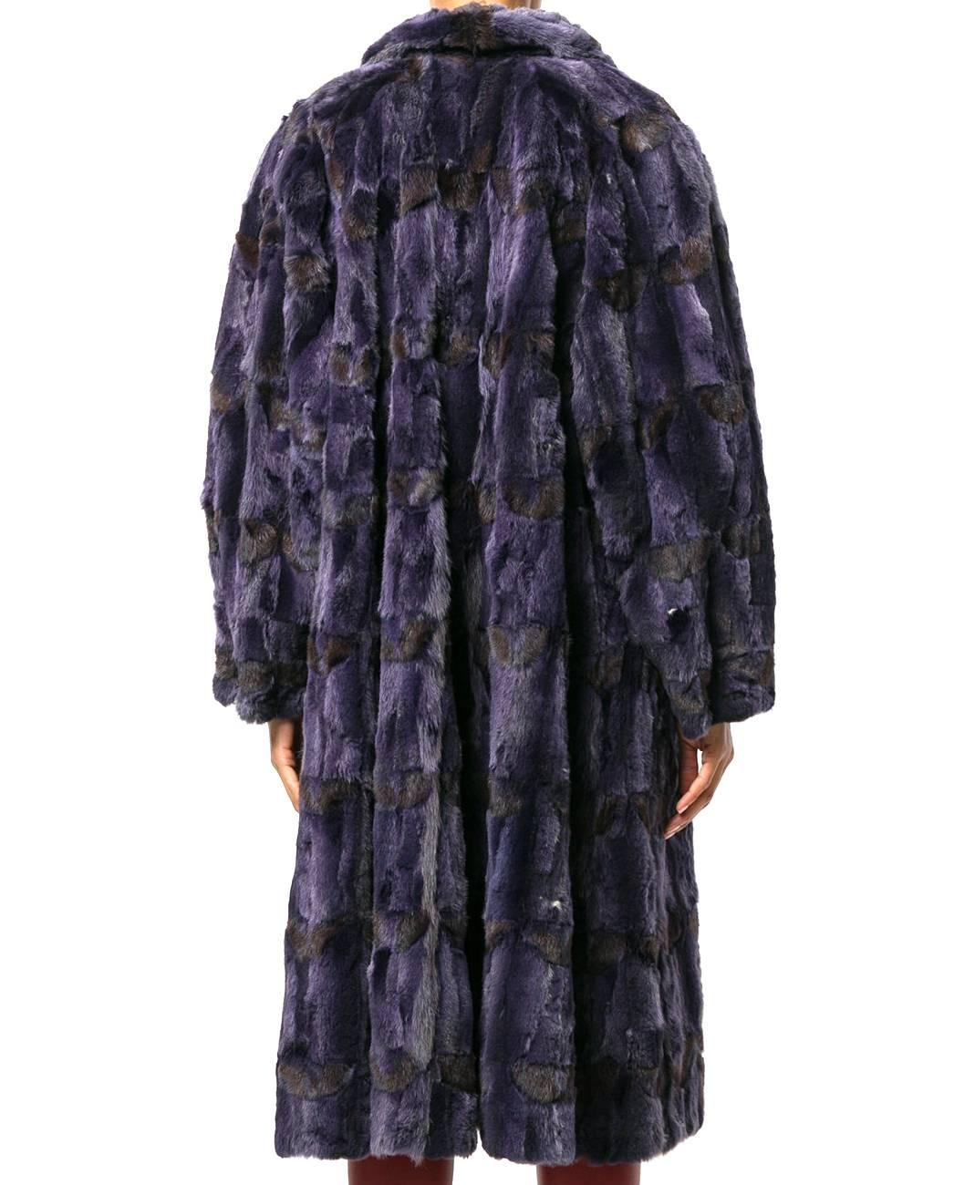 Marvelous Fendi purple fox fur, mink fur and silk long coat with shades of dark brown. It features a flared shape, long sleeves a closure with big logoed plastic button on the front and a hook. The item is vintage, it was produced in the 90s and is