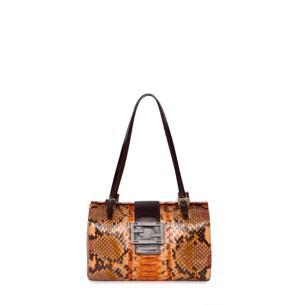 This luxurious Fendi Python Bag is the perfect blend of exotic materials and timeless style. Crafted from genuine python leather, it exudes sophistication with its smooth texture and intricate pattern. The leather detailing and buckle closure