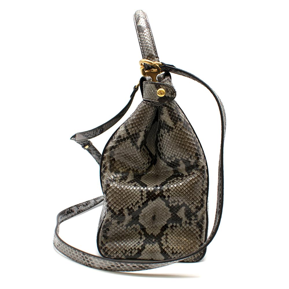 Medium Fendi Peekaboo  handbag made with 2 compartments divided by a stiff partition. Twist lock on both sides. Lining with zip pocket. Single handle and thin, adjustable, detachable cross-body strap. Made of grey python. Gold-finish metalware.

-