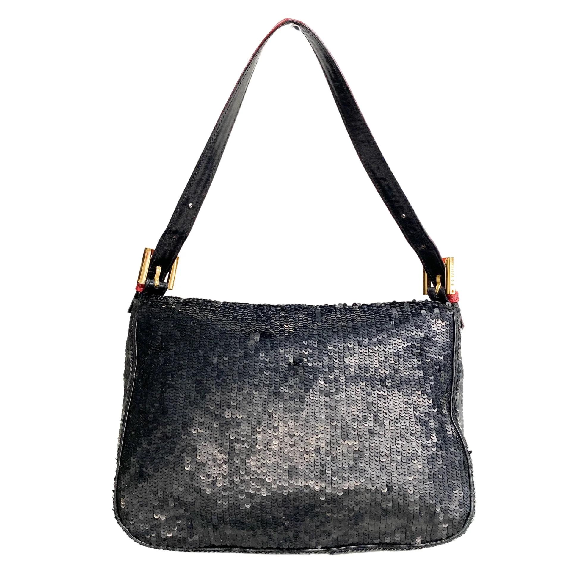 This Fendi Mama Baguette is constructed of black shimmering sequins with red python-embossed leather trim. The fold-over flap is secured with a contrasting red strap and a signature FF buckle with a magnetic snap closure.

Size: Small
Color: Sequins