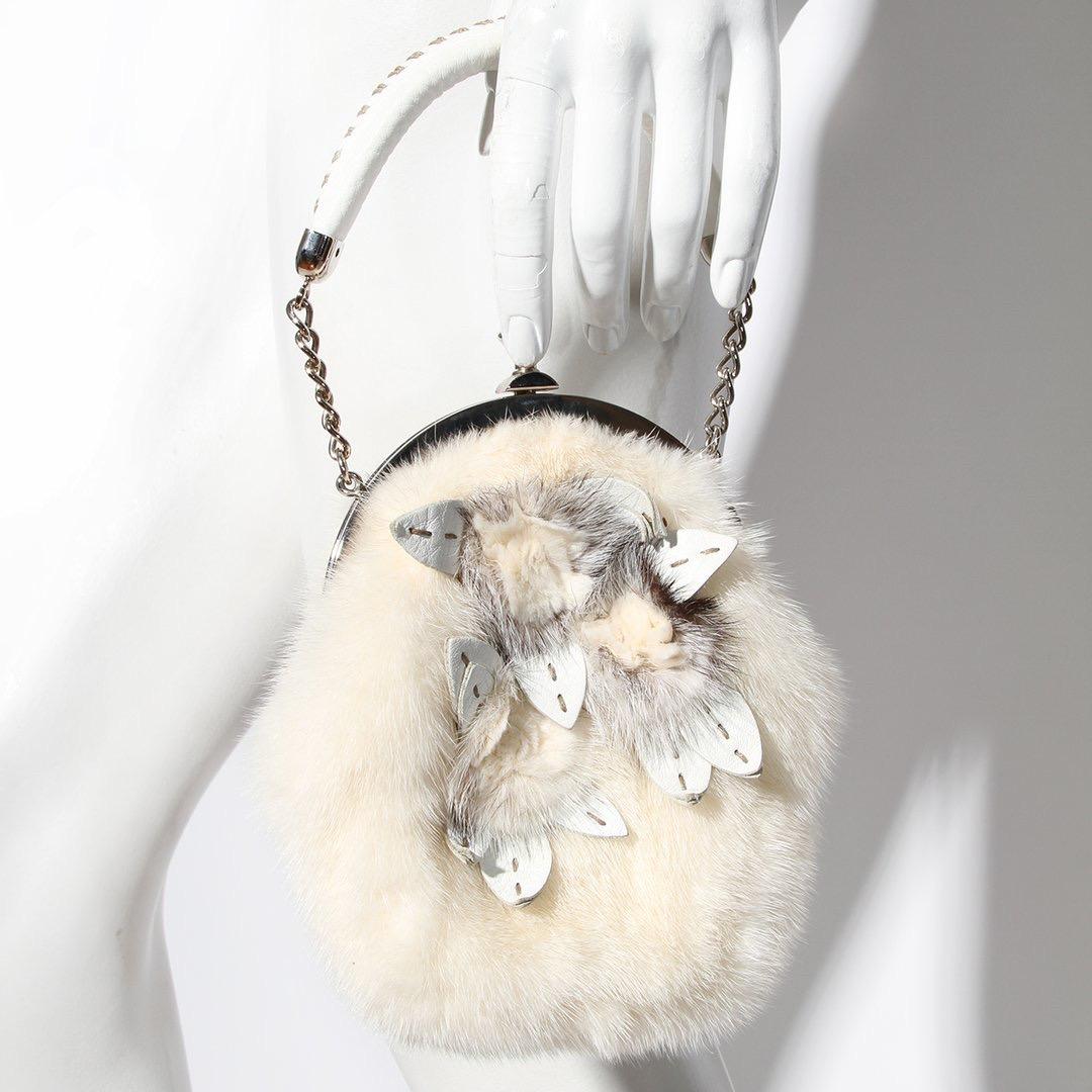 Fendi by Karl Lagerfeld Evening Handbag 
Made in Italy 
Ivory 
Rabbit Fur 
Fur rosettes with white leather leaves 
Leather leaves have stitch details 
Frame style evening bag 
Silver clasp closure stamped Fendi 
Silver chain with white leather