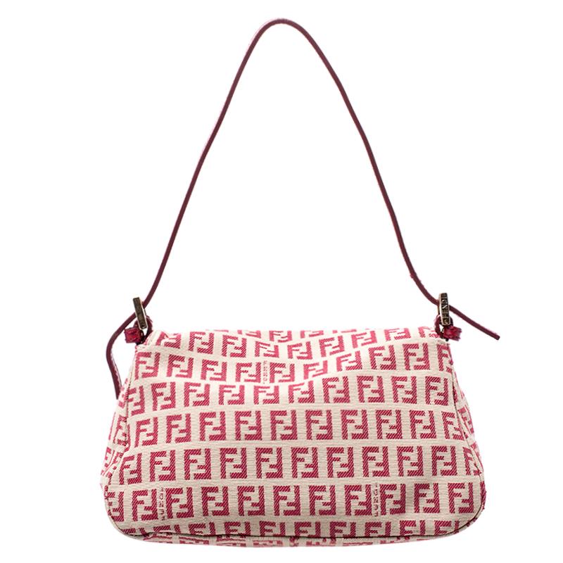 The Mama Baguette bag from Fendi is an all-time classic. Accented with the striking Forever lock in gold tone on the front flap, the piece carries a canvas exterior and a spacious interior sized to hold all your essentials. A leather strap completes