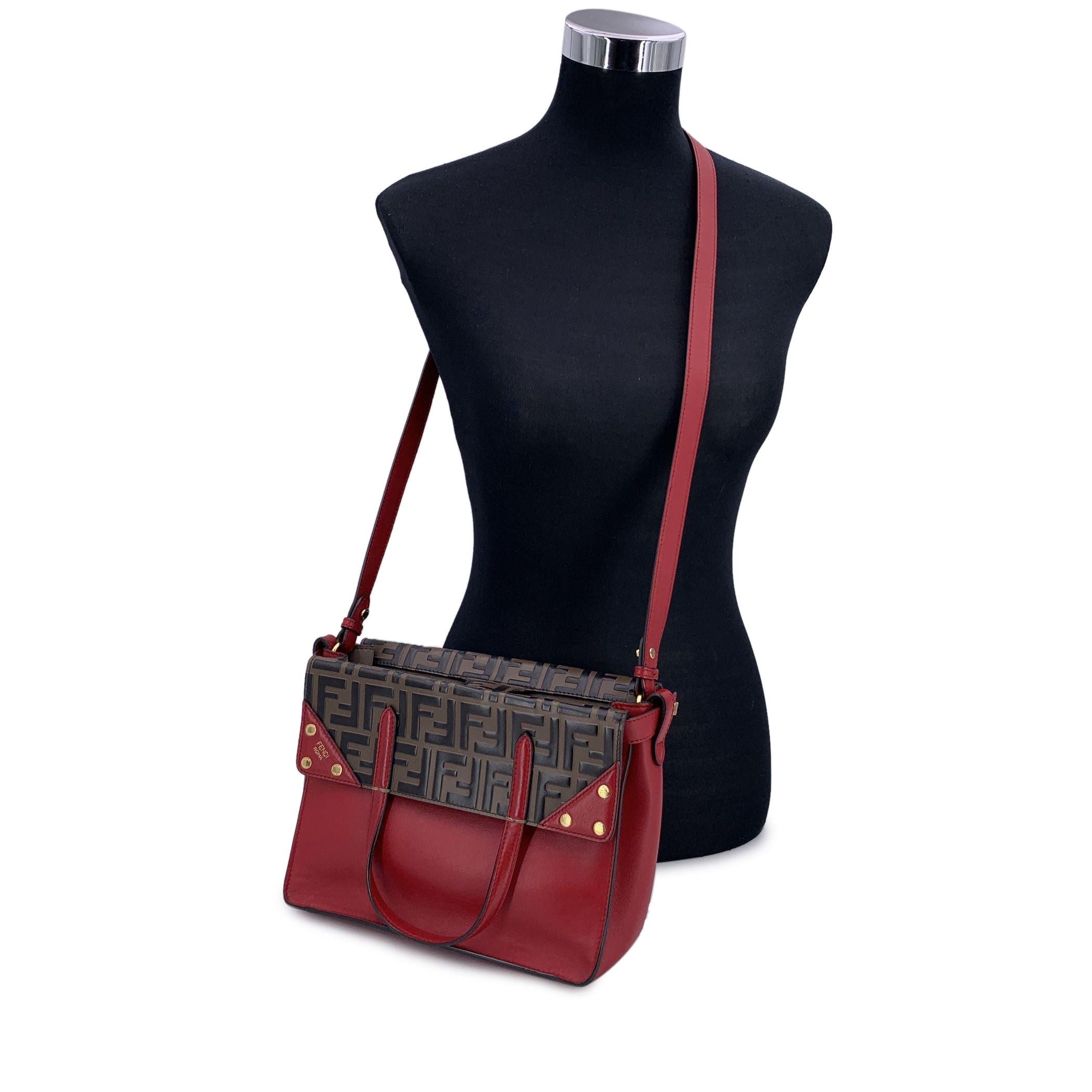 This beautiful Bag will come with a Certificate of Authenticity provided by Entrupy. The certificate will be provided at no further cost Step into a world of refined elegance with the Fendi Bi-Color FF Monogram Embossed Flip Tote in red color.