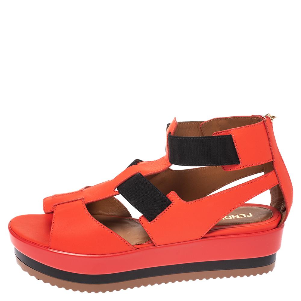 These stylish and edgy sandals by Fendi are a great way to add some statement to an outfit. Crafted from quality leather, they come in striking hues of red and black. They are styled with open toes, elastic bands, strappy silhouette, covered counter