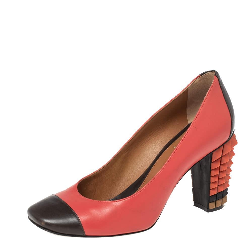 Strike a pose in these stunning Fendi pumps! The red and black pumps are crafted from leather and styled with square cap toes and studded block heels. They are complete with comfortable leather insoles and will prove to be an investment-worthy buy!