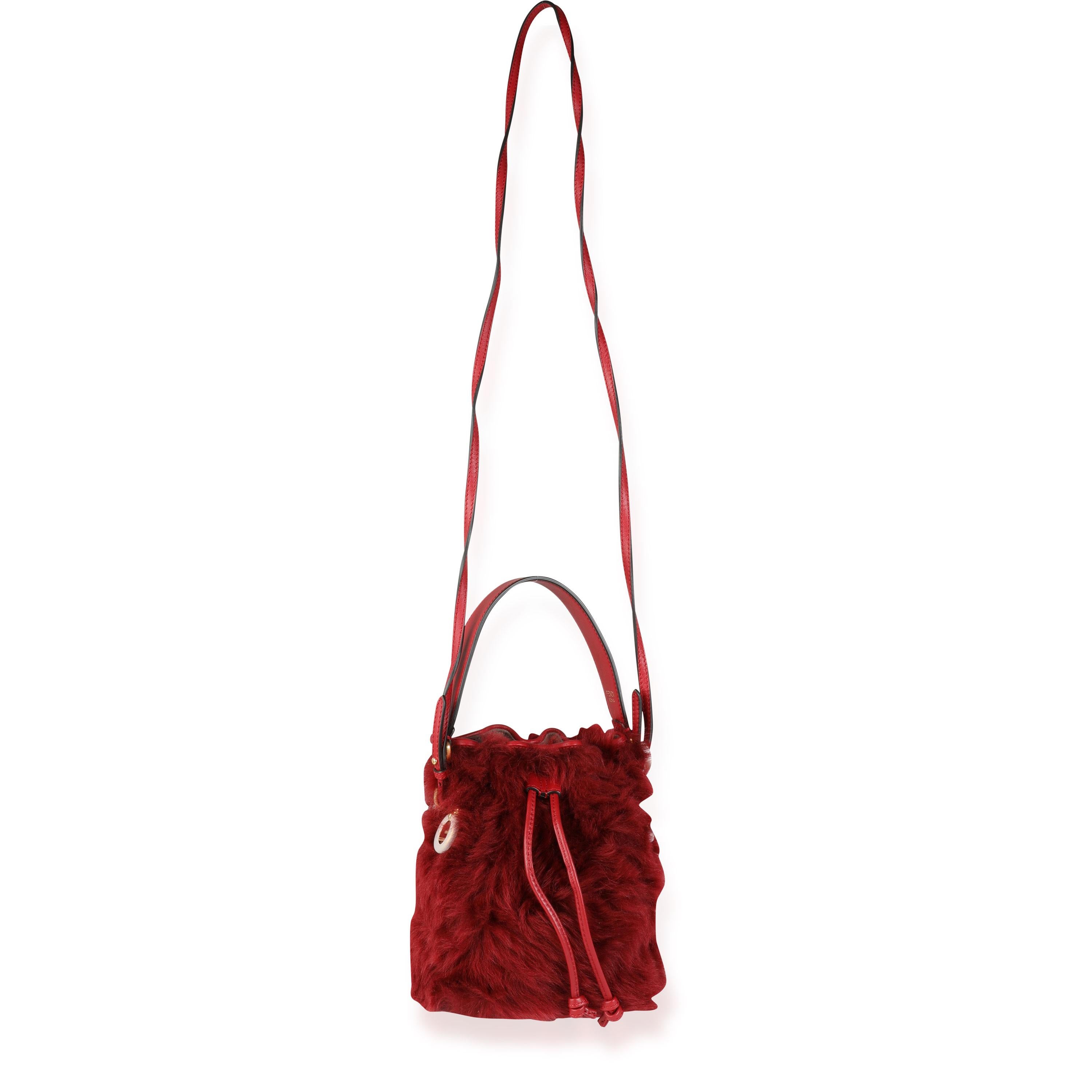 Listing Title: Fendi Red Lamb Fur & Calfskin Leather Mini Mon Trésor Bucket Bag
SKU: 116240
MSRP: 2400.00 USD
Condition: Pre-owned 
Condition Description: Fendi unveiled the Mon Tresor bucket bag on the Resort 2018 catwalk. Topped with a drawstring,