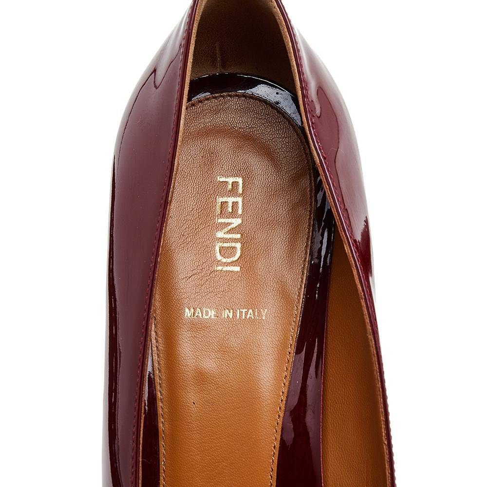 Fendi's timeless aesthetic and stellar craftsmanship in shoemaking is evident in these versatile pumps. Crafted from red patent leather, the round-toe silhouette is adorned with sleek cuts and then raised on sturdy heels.

