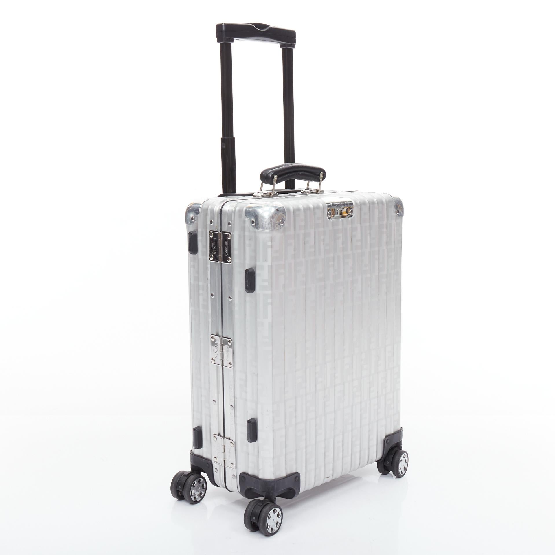 FENDI RIMOWA Cabin Size Zucca monogram silver aluminium trolley suitcase
Reference: YIKK/A00043
Brand: Fendi
Model: Team On
Collection: RIMOWA
Material: Metal, Leather, Fabric
Color: Silver, Black
Pattern: Striped
Closure: Push Clasp
Lining: Black