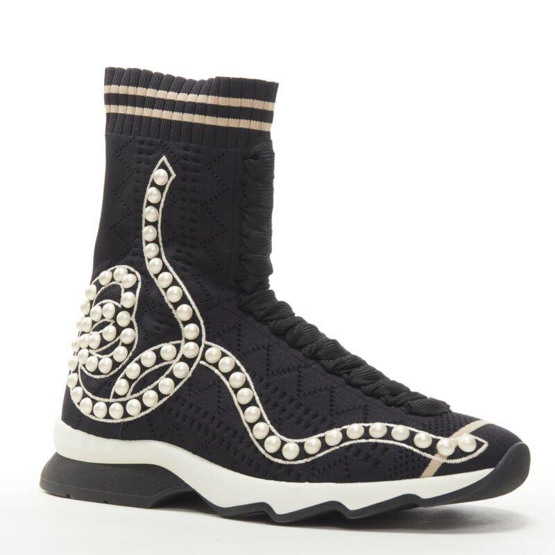 FENDI Rockoko black pearl embellished black sock knit high top sneaker EU36
Reference: ANWU/A00371
Brand: Fendi
Model: Rockoko
Material: Fabric
Color: Black, White
Pattern: Solid
Extra Details: Stretch fit. Perforated sock knit with faux pearl