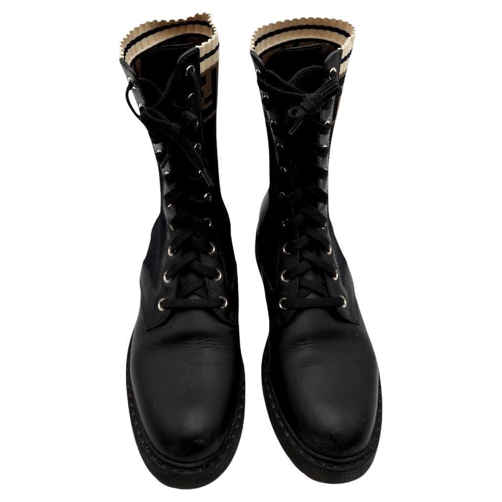 Fendi Rockoko Combat Boots – Black Leather & Knit FF Logo

Edgy meets luxury in these Fendi Rockoko lace-up boots, crafted in smooth black leather with a stretch knit sock shaft featuring the iconic FF logo. The mid-calf silhouette balances