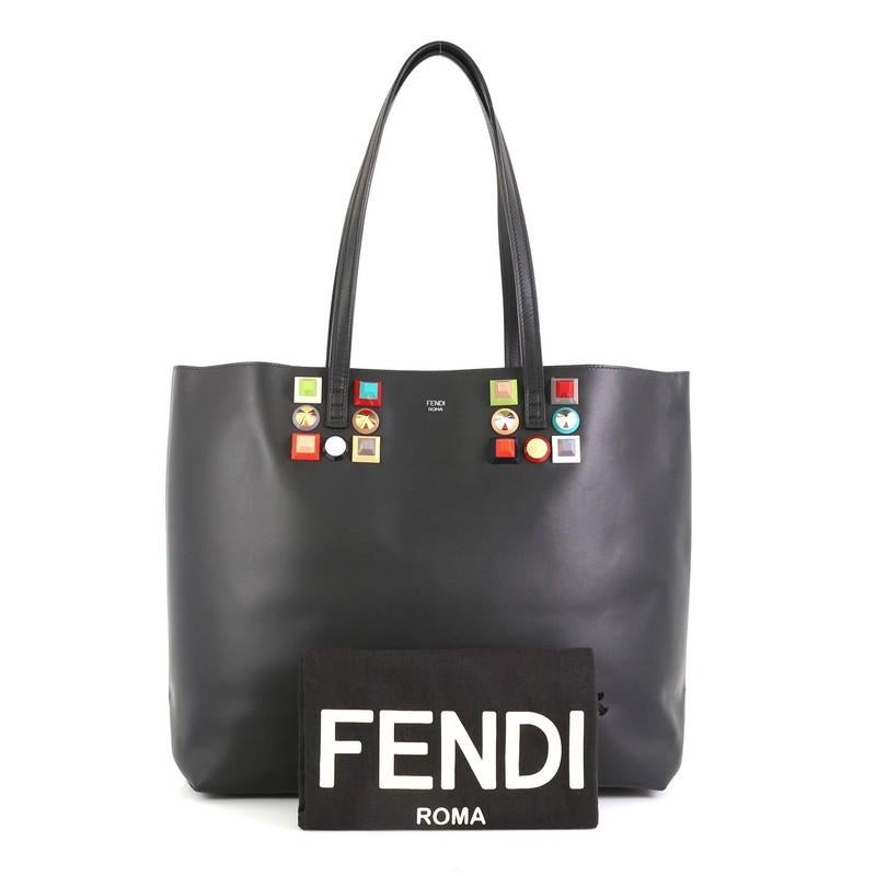 This Fendi Roll Tote Studded Leather Medium, crafted from black studded leather, features dual slim straps and silver-tone hardware. It opens to a black leather interior. 

Estimated Retail Price: $1,800
Condition: Excellent. Minor wear on base