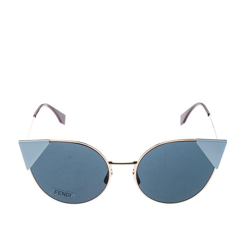Crafted in a sharp cat-eye silhouette, these Fendi sunglasses are made out of an acetate and metal body and detailed with gold-tone hardware. It comes with blue tinted lenses and detailed with a cap at the cat-eye wing. This shape particularly