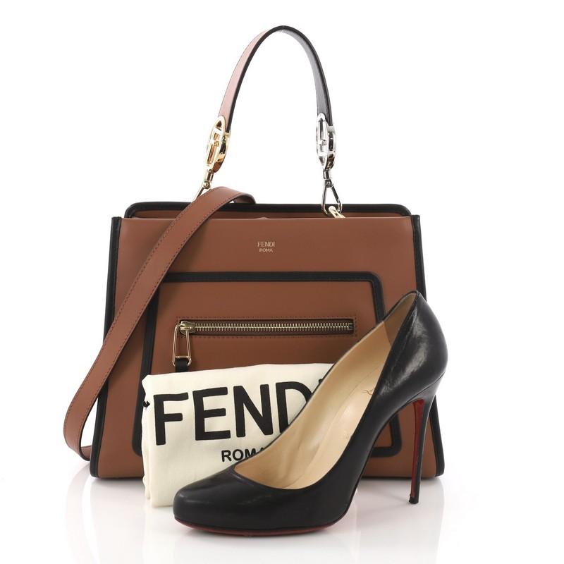 This Fendi Runaway Handbag Leather Small, crafted from brown leather, features a flat leather handle, exterior zip pocket, and silver and gold-tone hardware. Its magnetic snap button closure opens to a gray microfiber interior with zip and slip