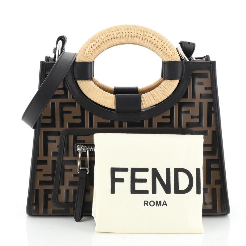 This Fendi Runaway Tote Logo Embossed Leather Small, crafted in black and brown zucca FF logo-embossed leather, features dual woven rattan handles, exterior front zip pocket and silver-tone hardware. It opens to a gray microfiber interior.