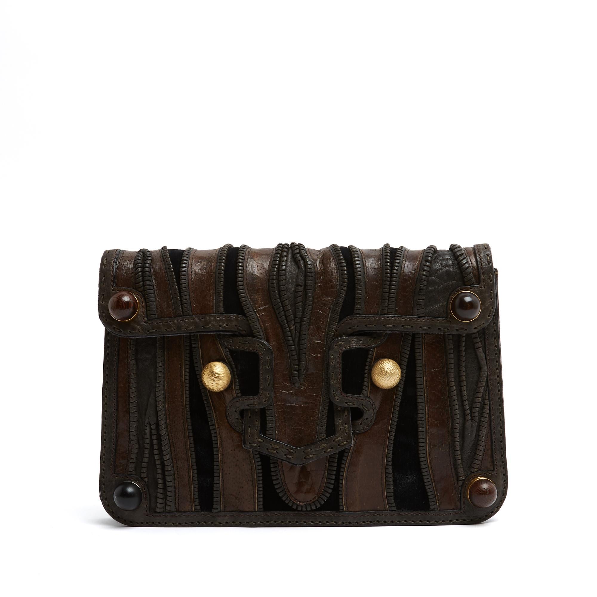 Fendi bag or clutch dressed in multiple materials aged leather, cut leather, velvet with wide stitching, in shades of brown and brown (almost black), enhanced with round wooden and gold metal studs, beige canvas interior with a patch pocket, large