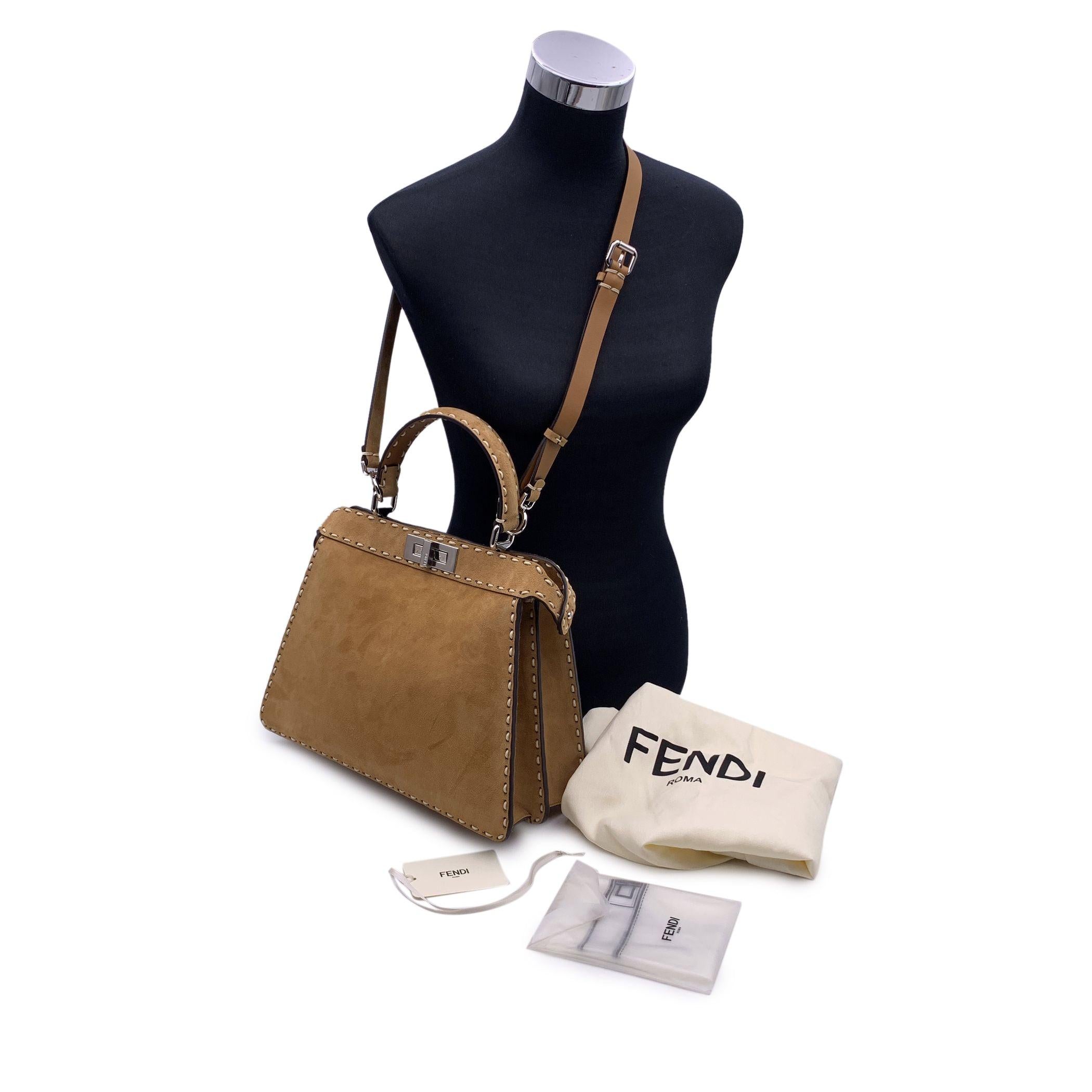This beautiful Bag will come with a Certificate of Authenticity provided by Entrupy. The certificate will be provided at no further cost. Beautiful Fendi Selleria 'Medium - Peekaboo ISeeU' Bag in beige suede wth contrast Sellerissima stitchings. The