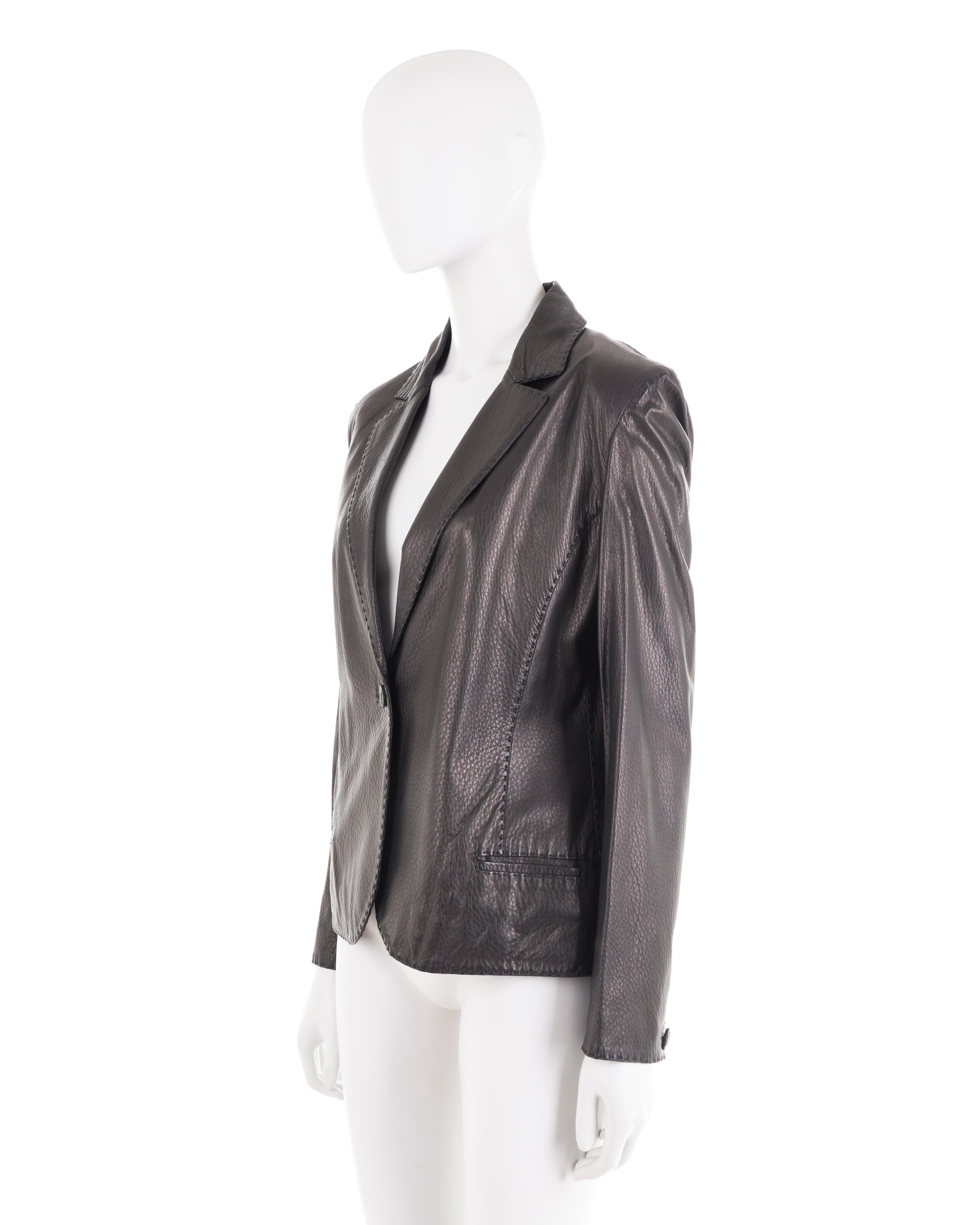 - Black lambskin fitted leather jacket
- “Fendi Selleria” line, handmade leather goods
- “Palazzo Fendi” embossed buttons
