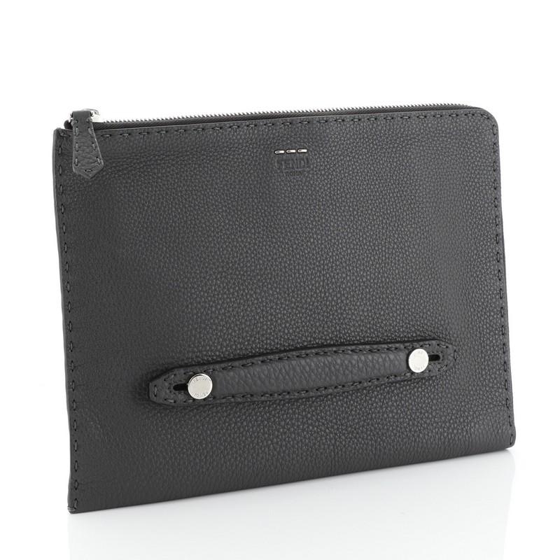 This Fendi Selleria Clutch Leather Medium, crafted from gray leather, features slot handclasp and silver-tone hardware. Its zip closure opens to a black fabric interior divided into three compartments with side zip and slip pockets.

Estimated